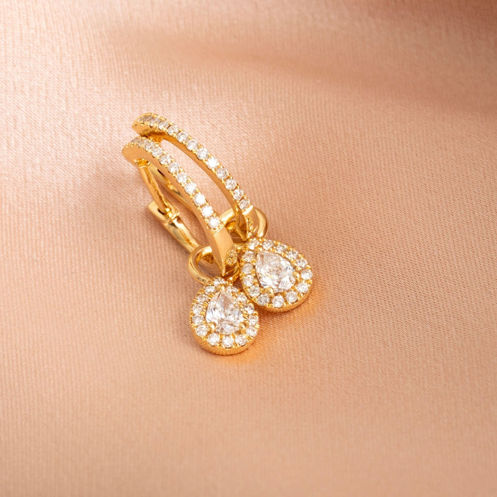 18ct gold diamond earrings on fabric
