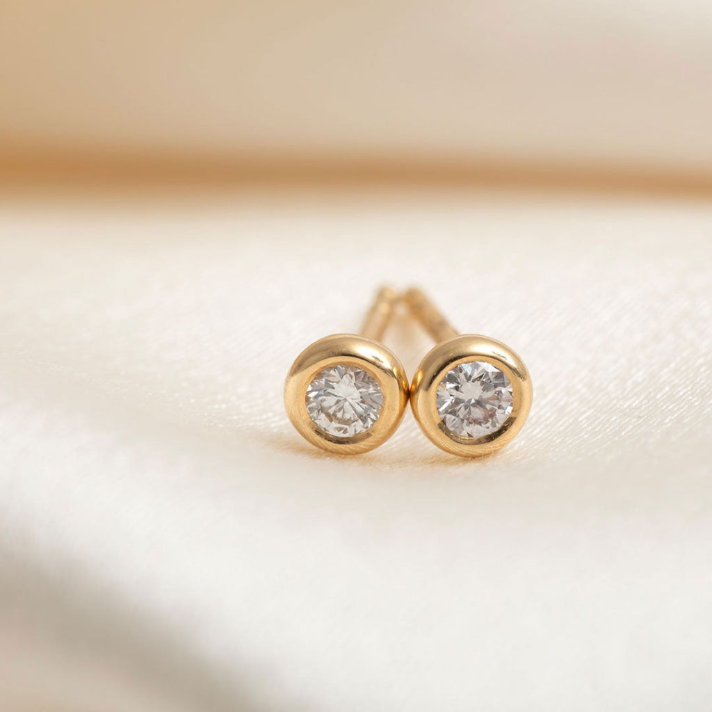 close up of yellow gold diamond studs