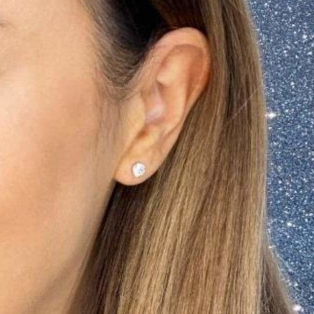 Woman wearing 9ct gold Classic 4mm Stud Earrings | Gear Jewellers Dublin