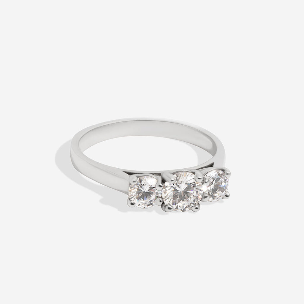 white gold three stone ring on white background side view