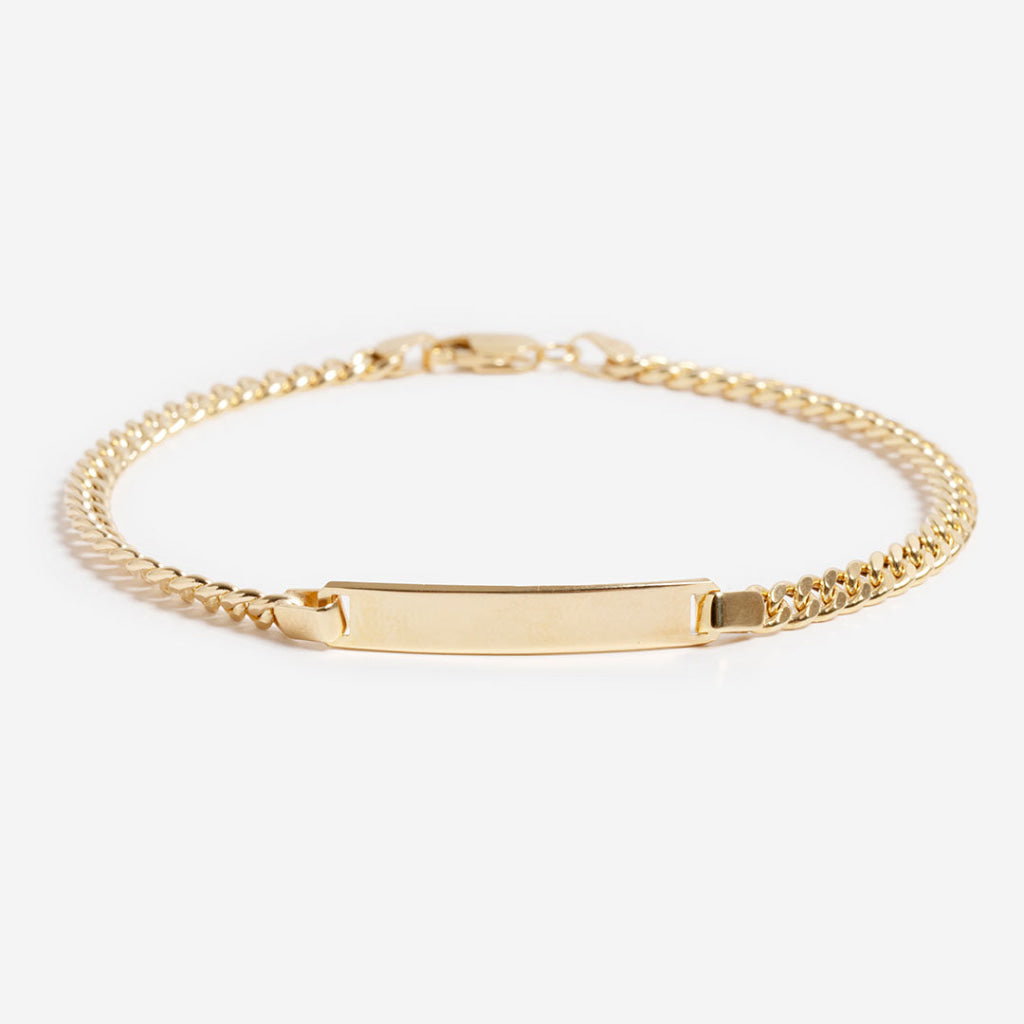 14ct gold id curb bracelet on white background