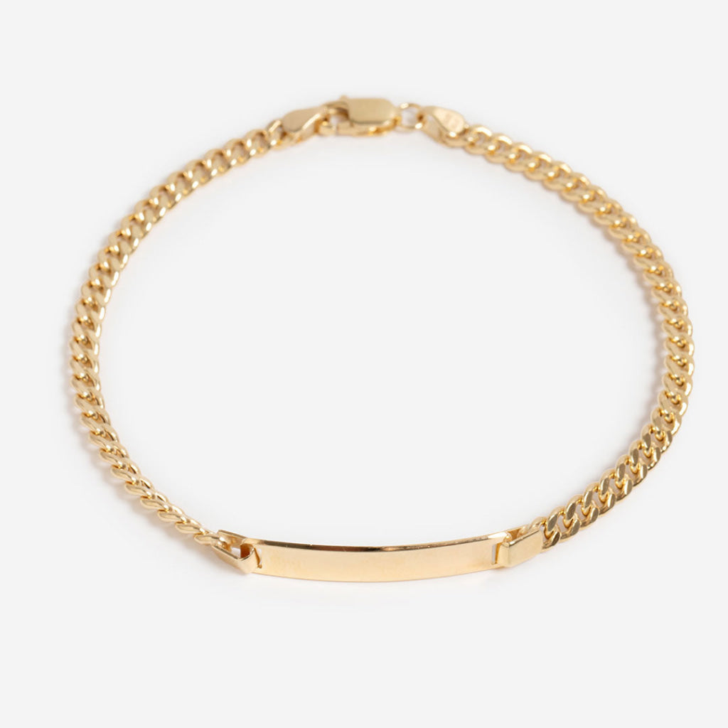 14ct gold id curb bracelet on white background