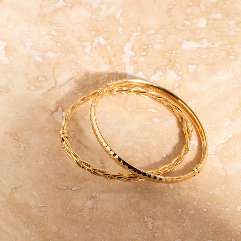 two yellow gold bangles stacked 