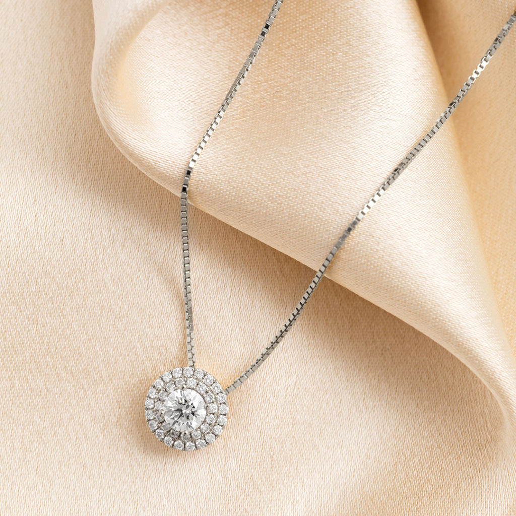 18ct white gold halo diamond necklace on fabric