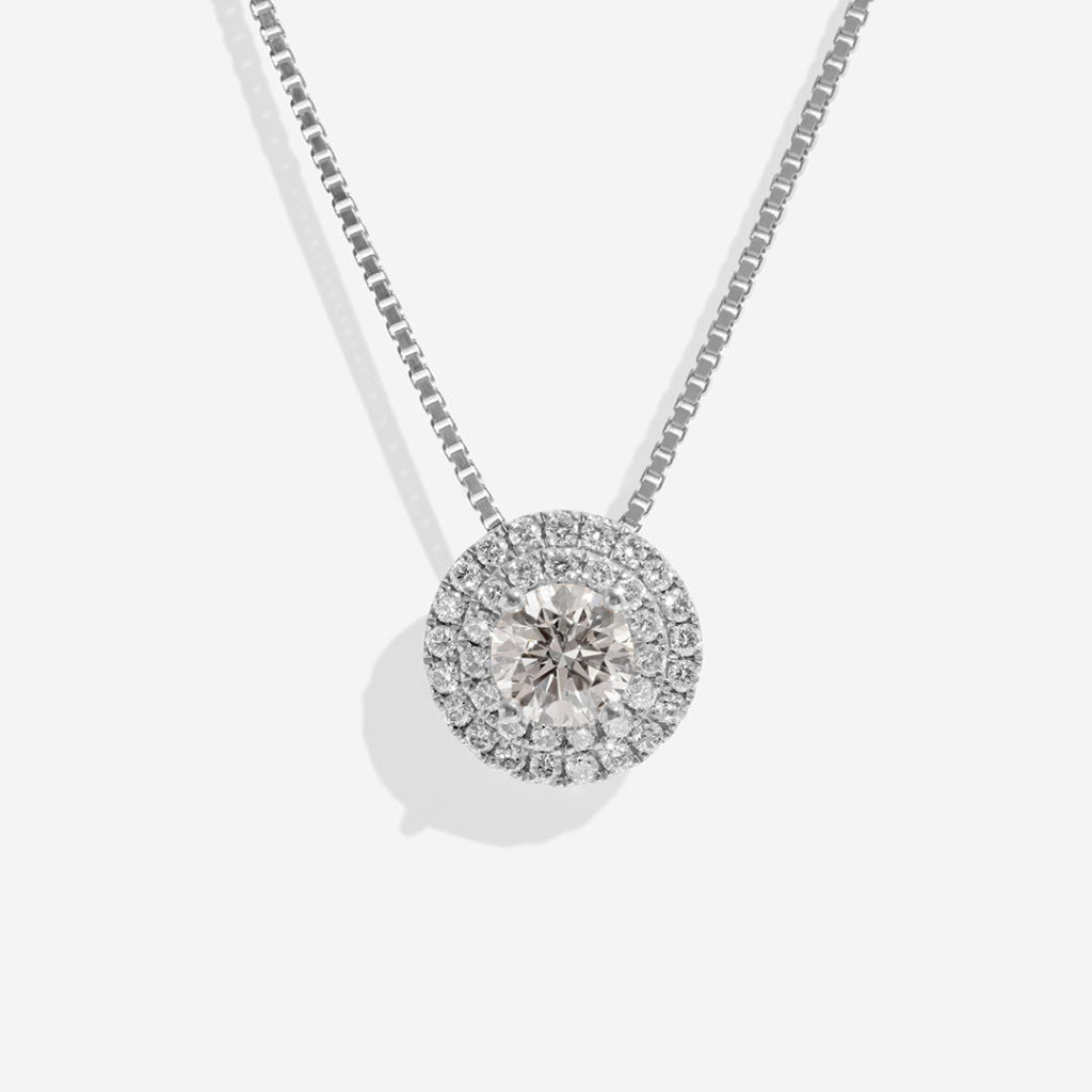 18ct white gold halo necklace on white background