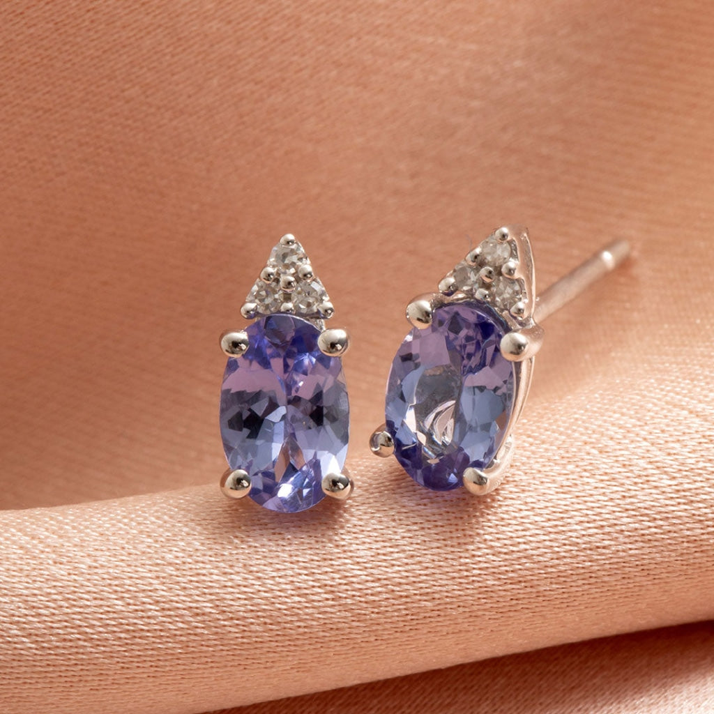diamond and tanzanite earrings on fabric