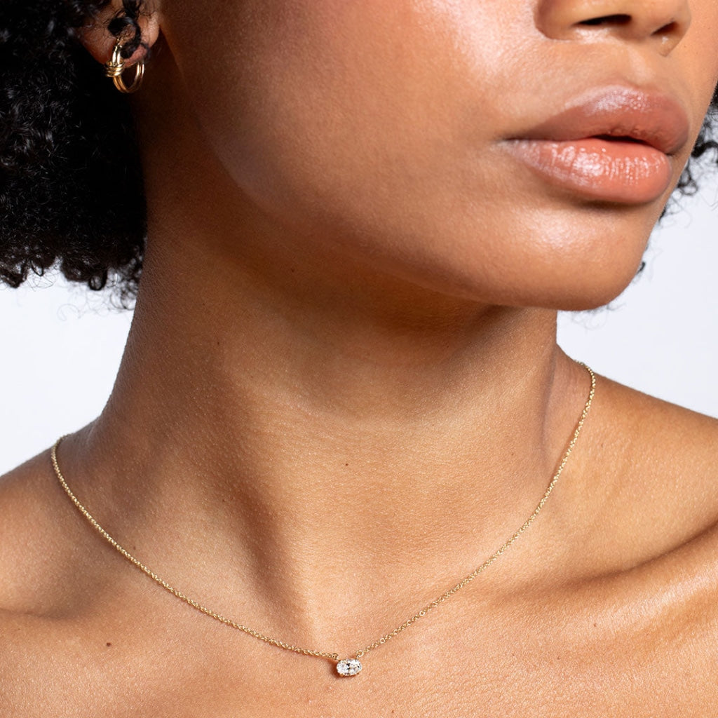 Lady wearing oval diamond necklace