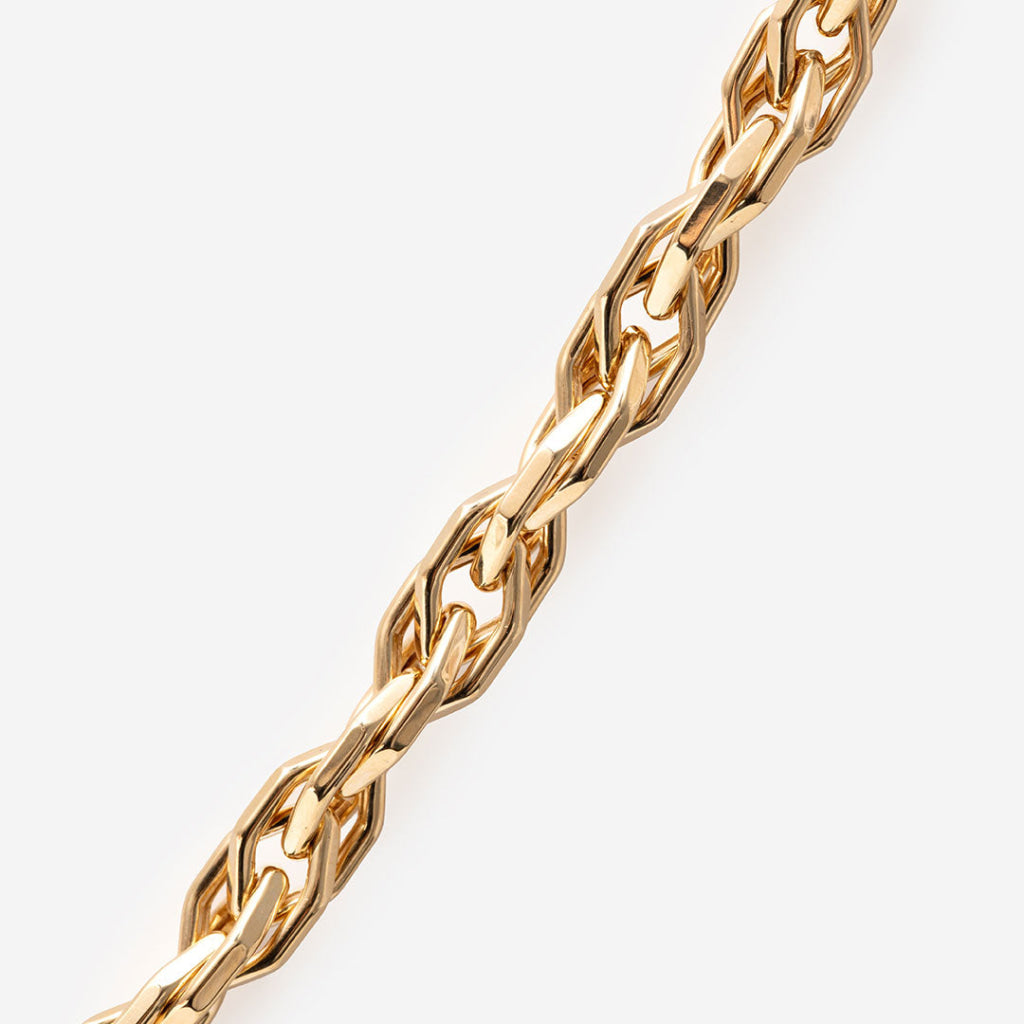 yellow gold fancy link chain on white background