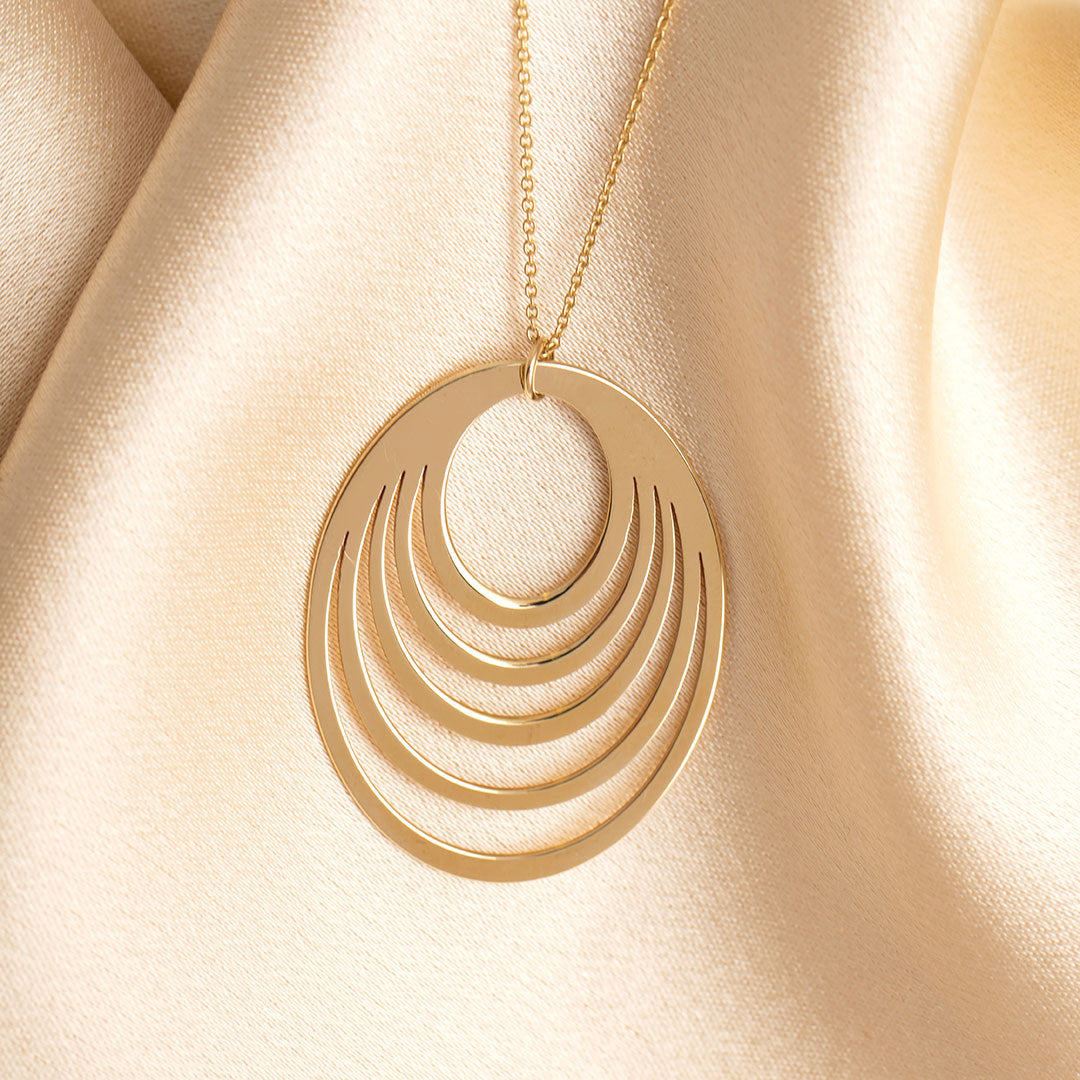 Gold Eclipse necklace on fabric