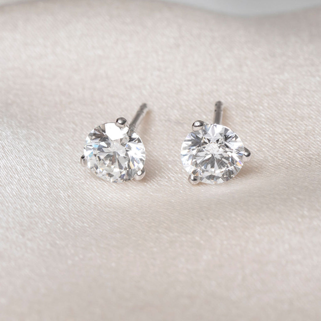 3 claw round diamond earrings.