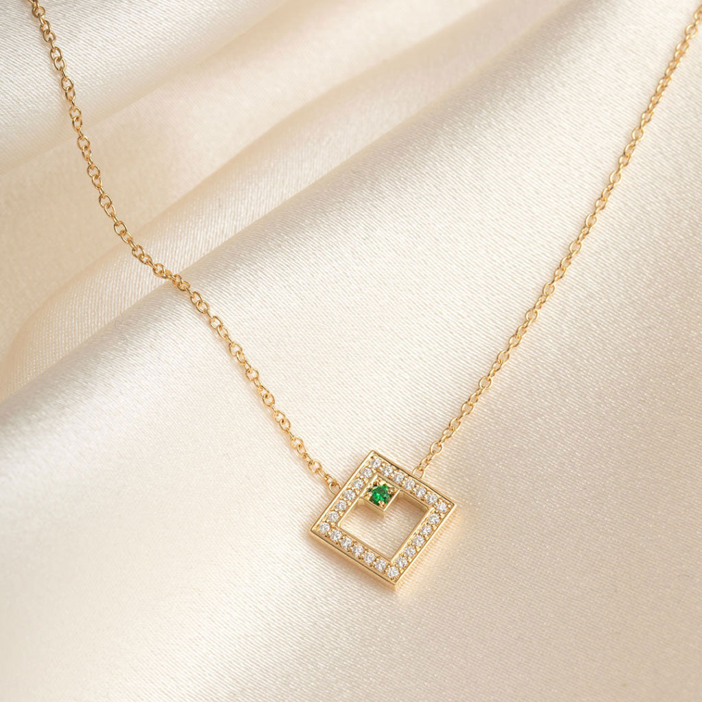 yellow gold diamond necklace with green tsavorite