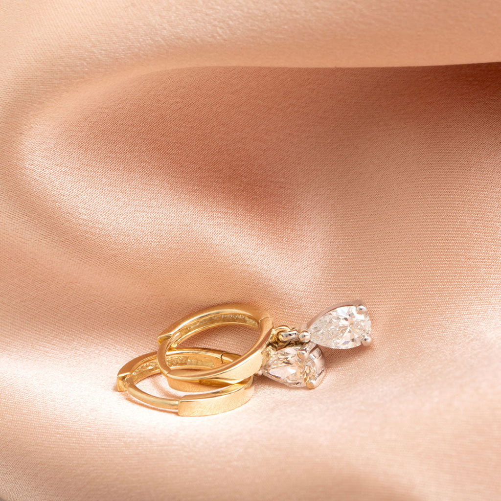 Hoop pear drop earrings on fabric