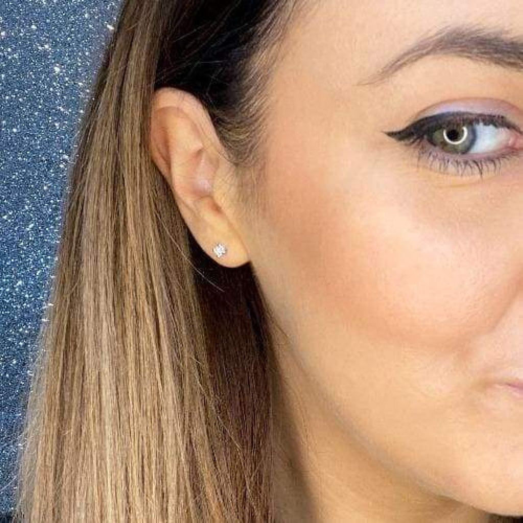 Woman wearing diamond earring.