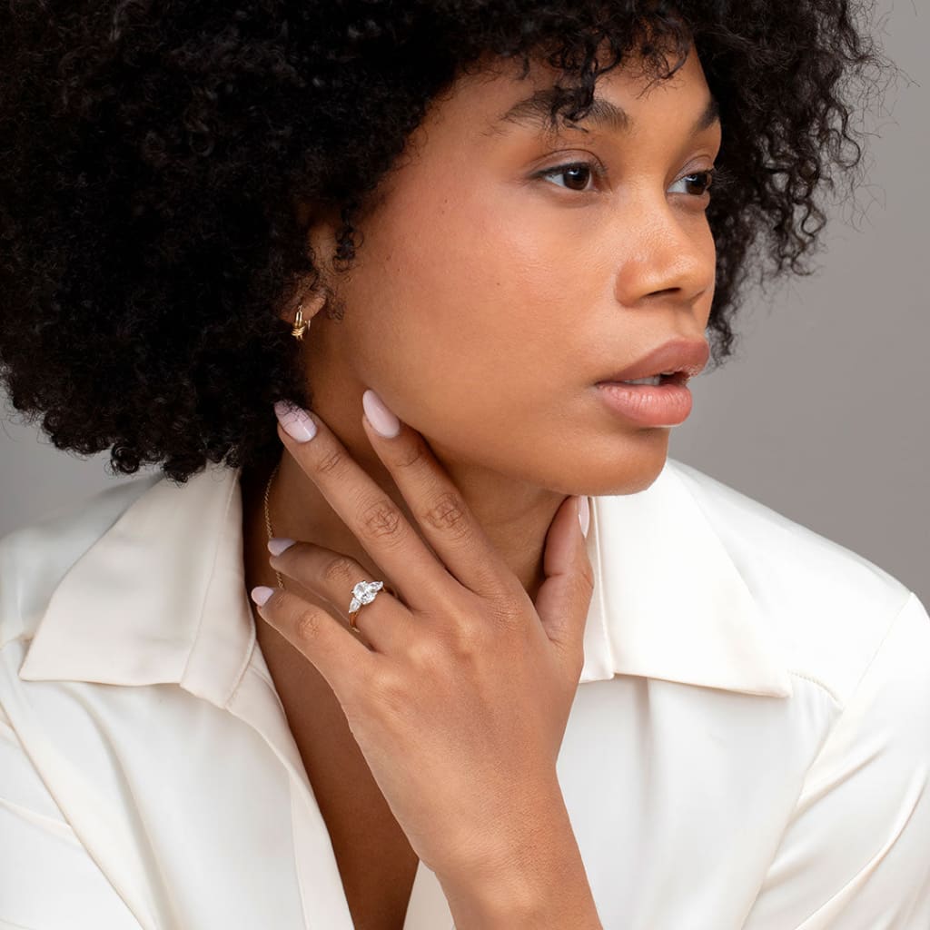 Three stone engagement ring on hand model