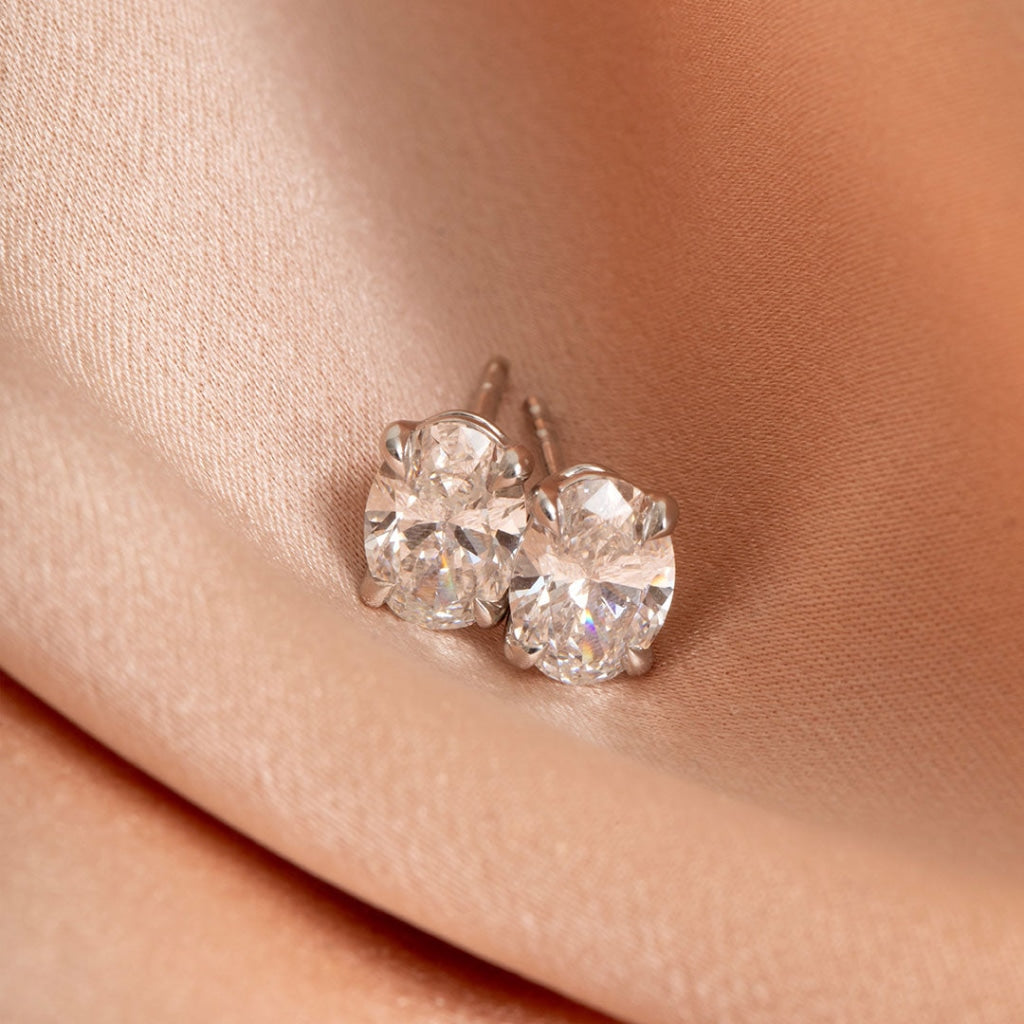 Oval lab diamond earrings on fabric