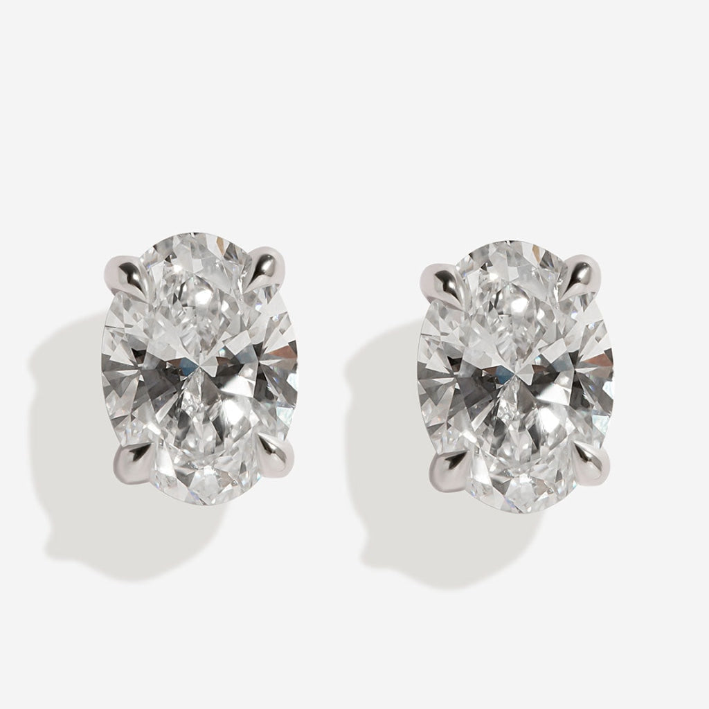 Oval diamond earrings on white background