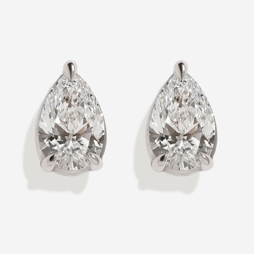 Pear diamond earrings on white background