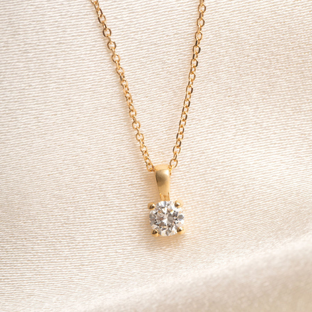 yellow gold diamond pendant on trace chain