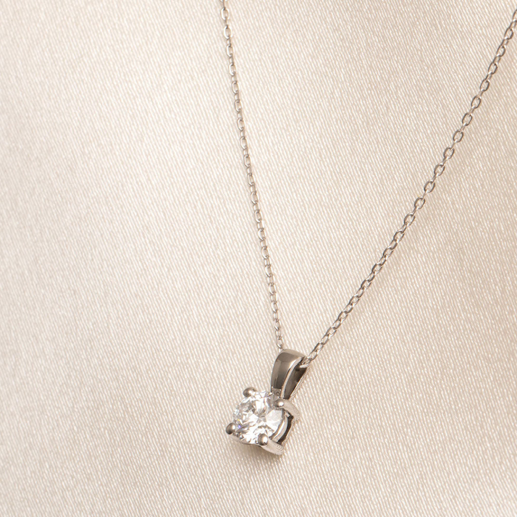 side view of diamond pendant on white gold trace chain