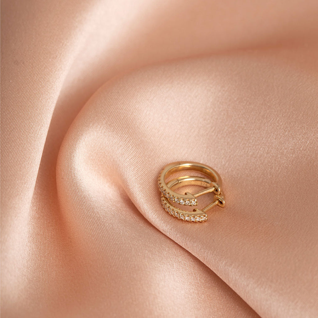 9ct gold diamond hoop on fabric