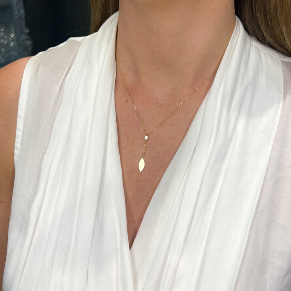 gold drop necklace on models neck