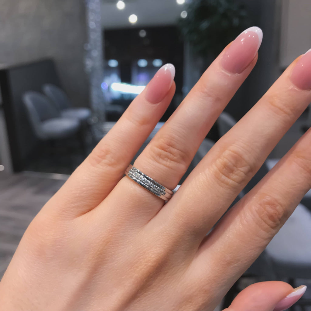 Diamond weddinf ring on womans hand.
