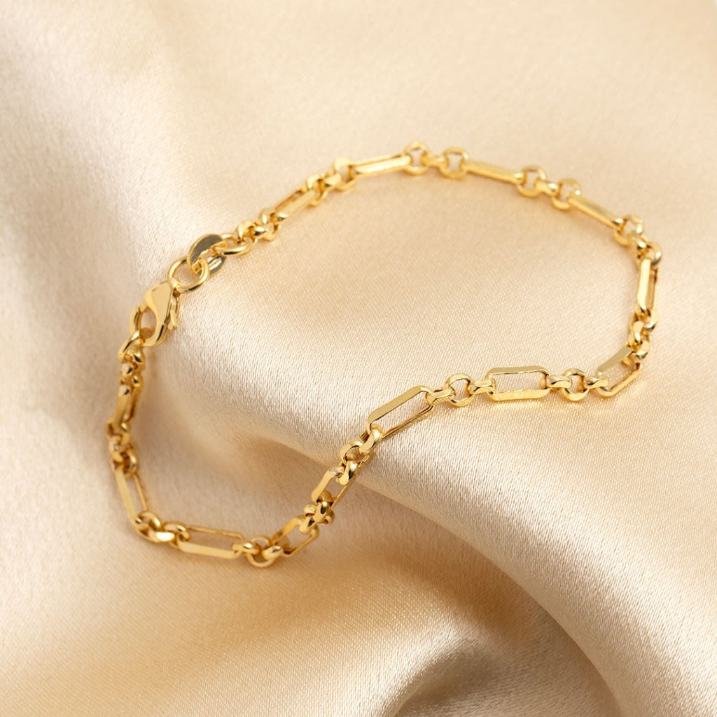 Ladies gold bracelet on fabric