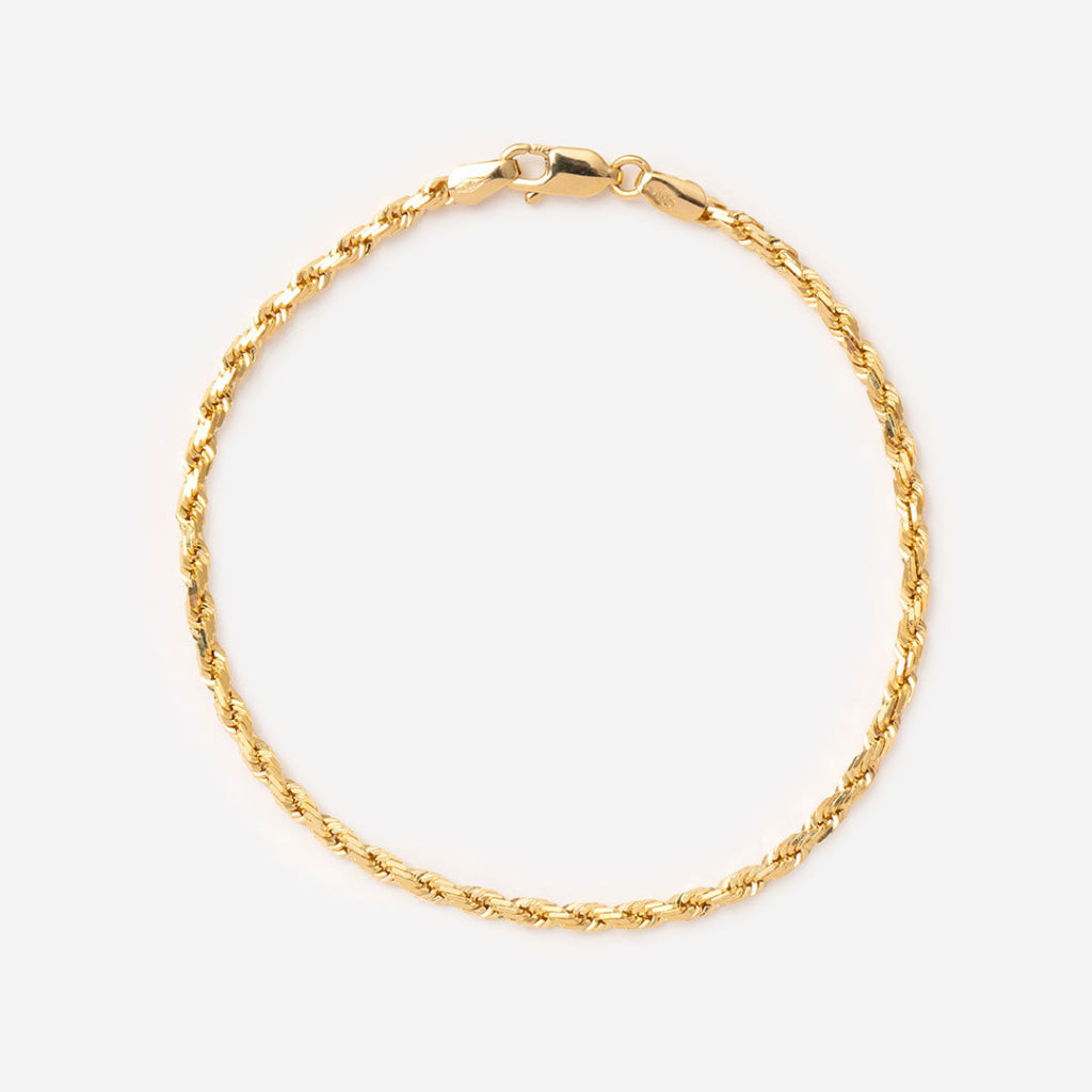 yellow gold bracelet on white background