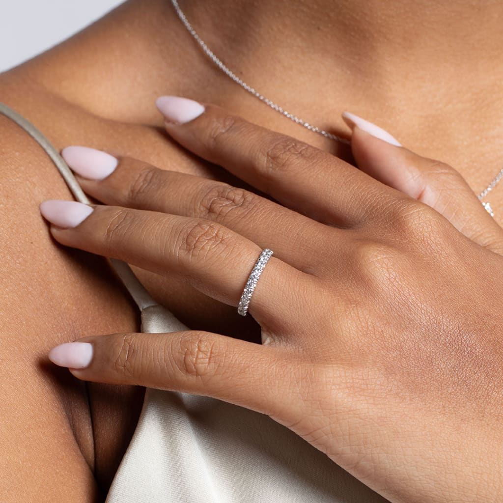 Model's hand wearing Fishtail diamond wedding ring in white gold - Photo 1