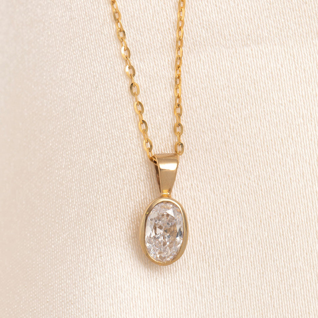 oval cut bezel set yellow gold pendant on chain