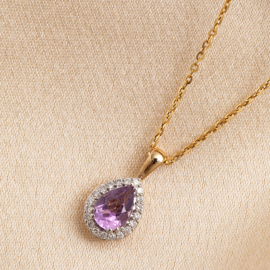 Amethyst and diamond necklace flat on fabric