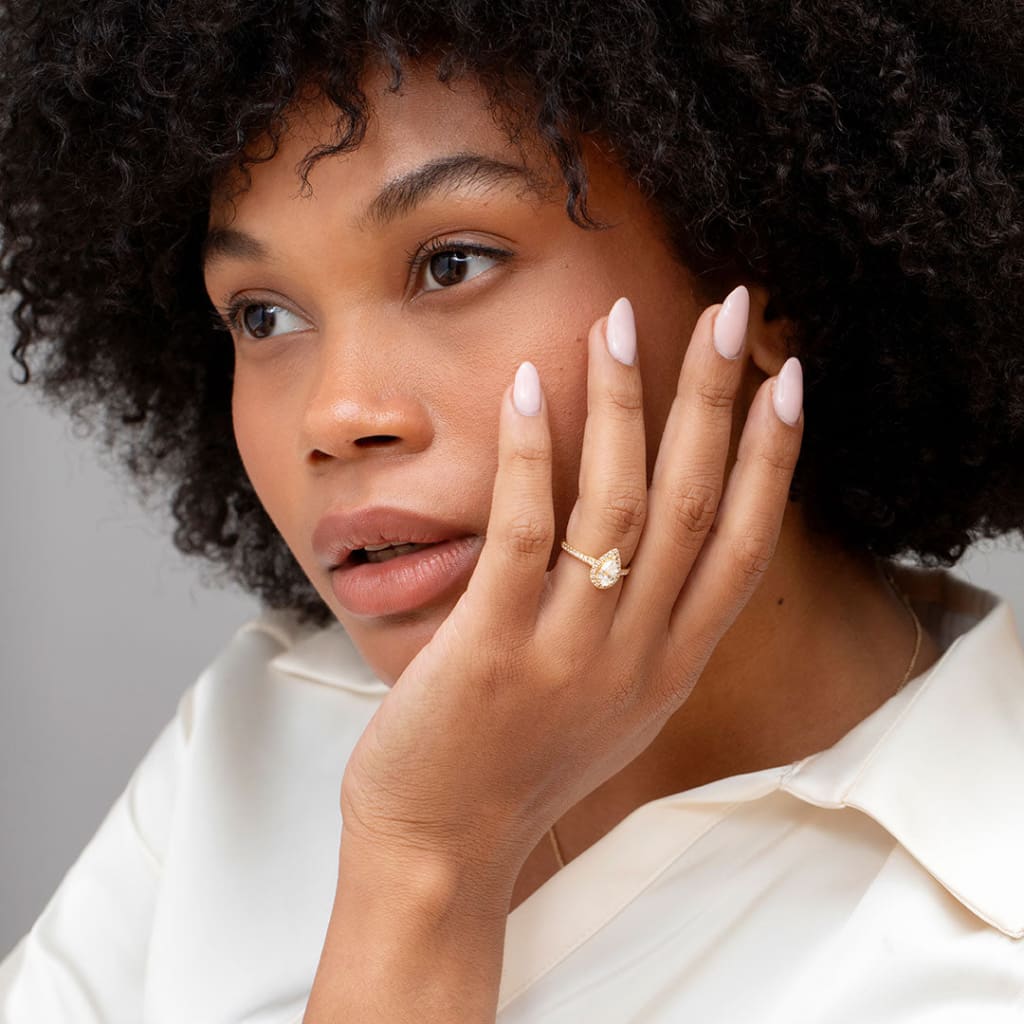 Lady wearing pear diamond Geneva engagement ring