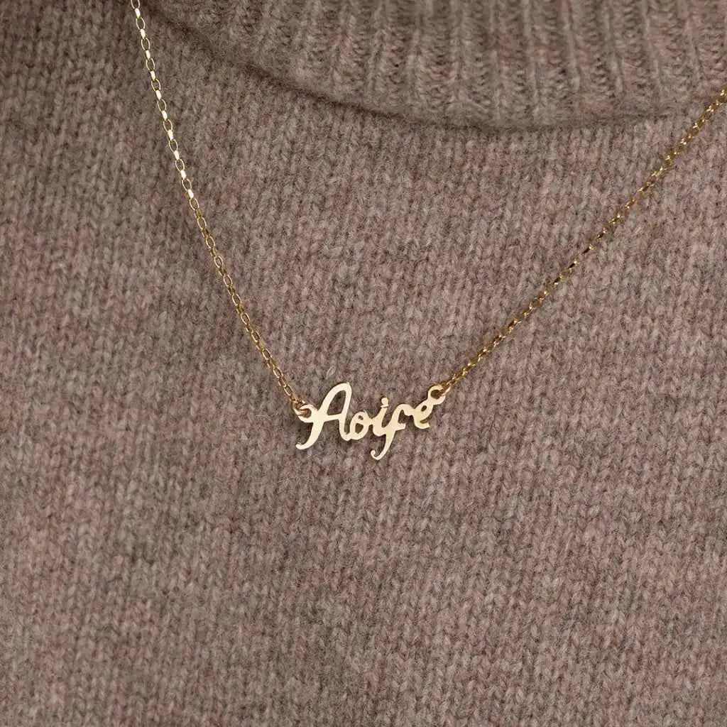 Image of woman wearing gold name chain necklace | Gear Jewellers Dublin