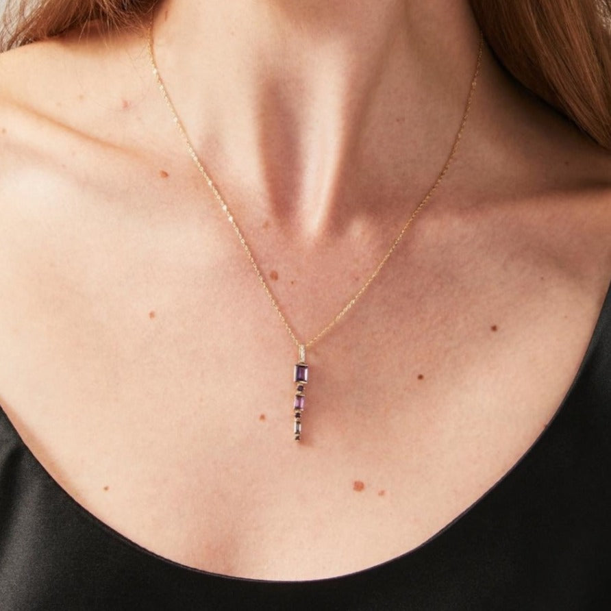 Amethyst and diamond necklace on models neck
