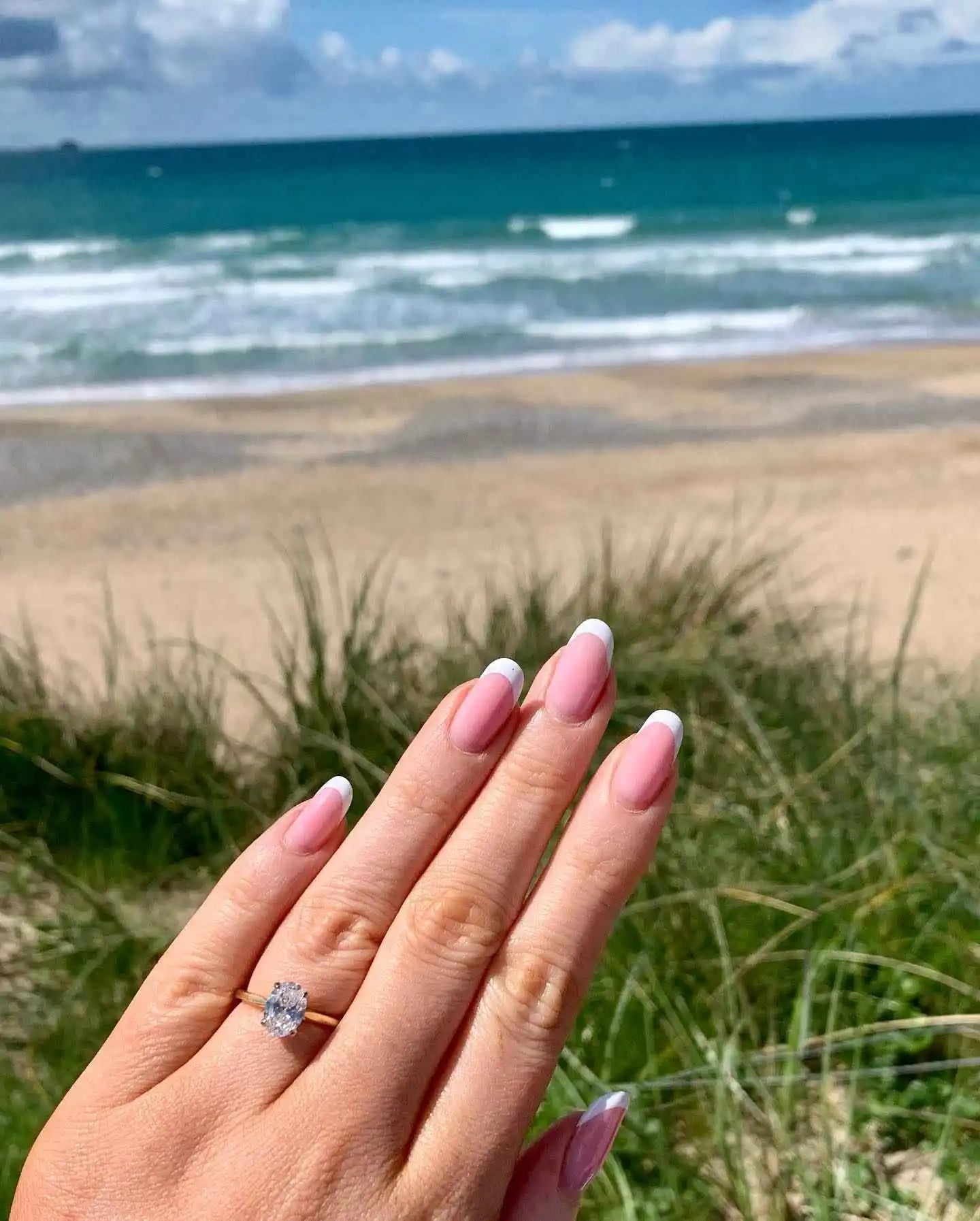 files/hand-pink-manicured-nails-solitaire-diamond-ring.webp