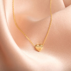 A delicate necklace with a sliding heart.  Crafted in superb quality 9ct gold 
