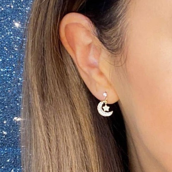 Woman wearing 9ct gold CZ Moon & Star Drop Earrings | Gear Jewellers Dublin