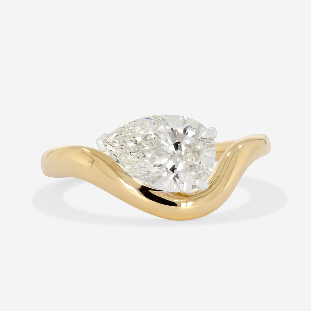 pear cut engagement ring on white background 