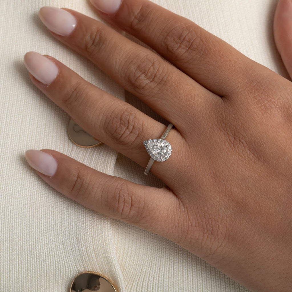 pear cut engagement ring on models hand