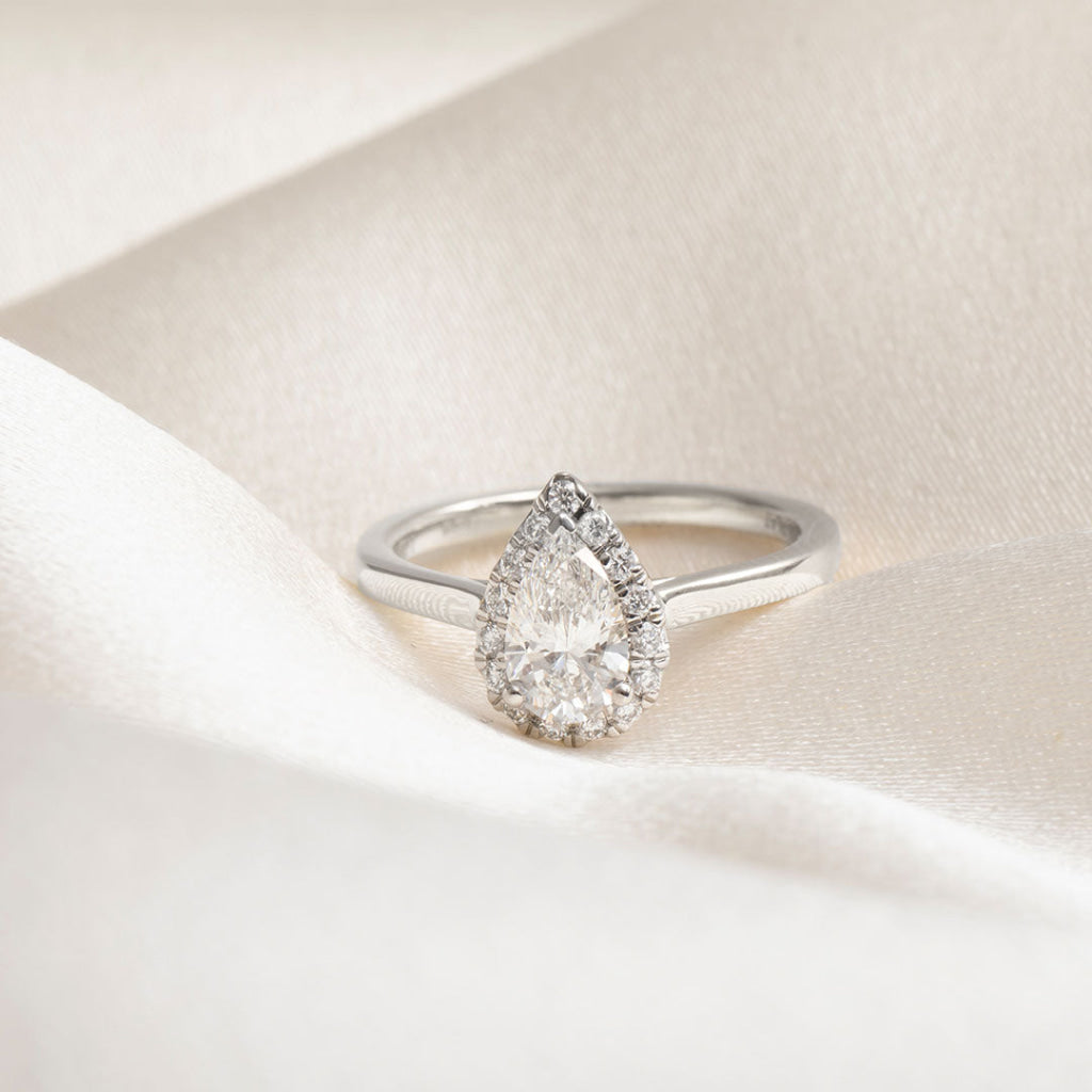 pear cut engagement ring on fabric