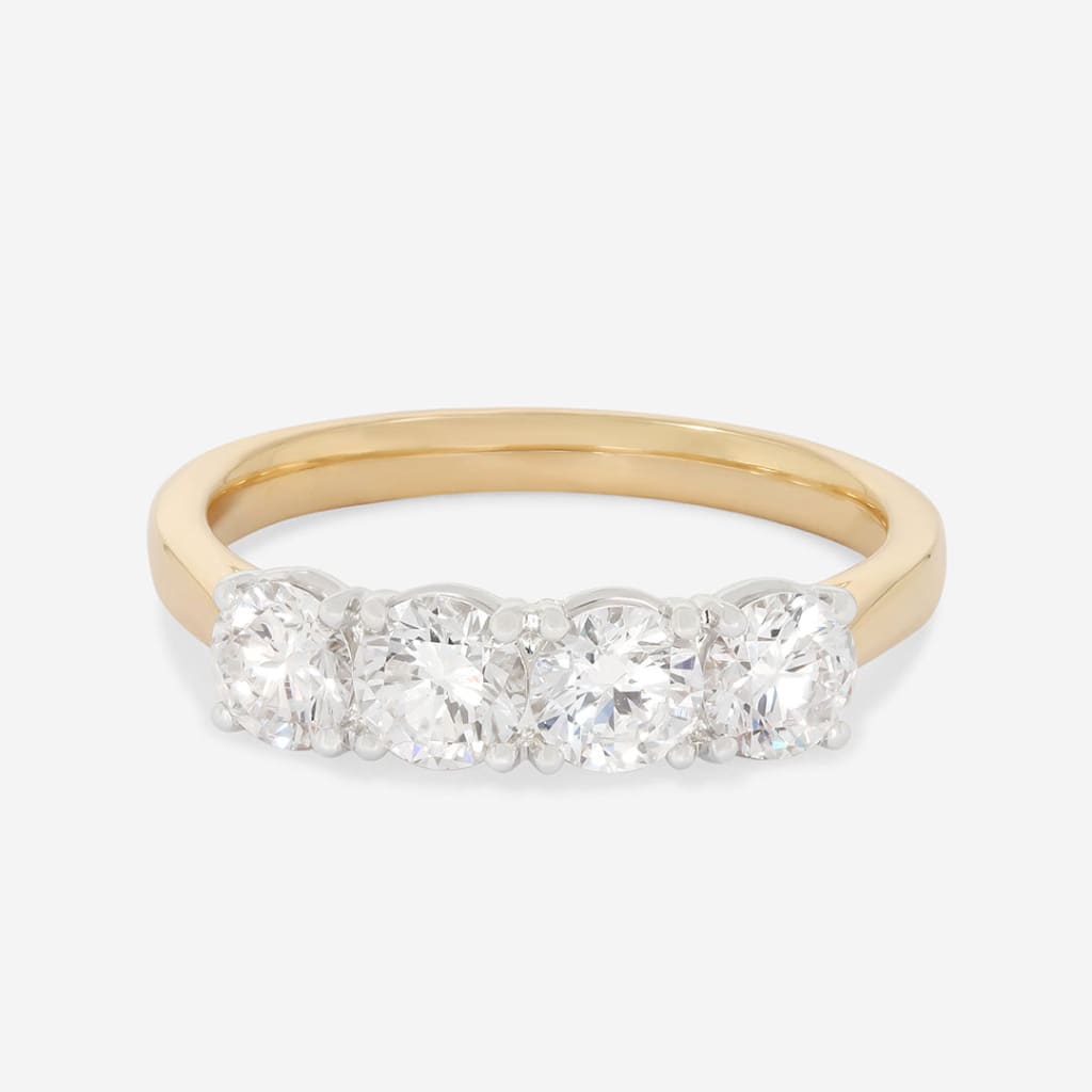 four diamonds set in a yellow gold band