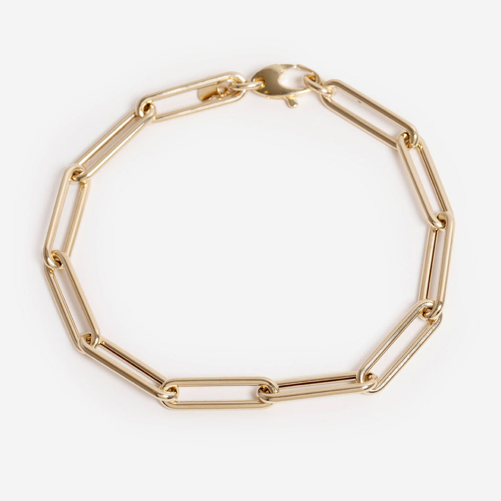 gold paperlink bracelet on white background