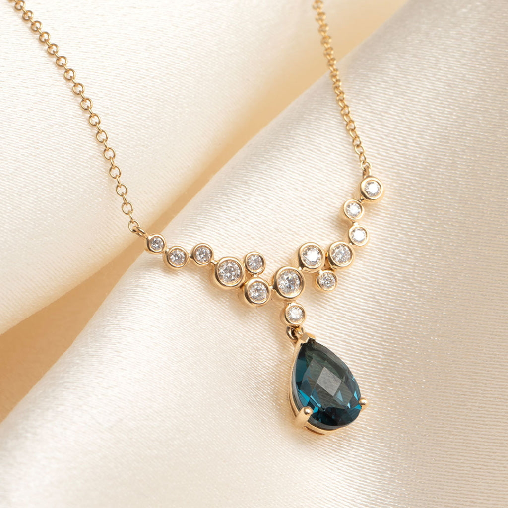 yellow gold diamond necklace with london blue topaz