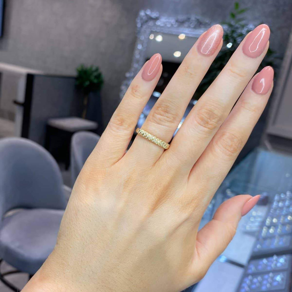 18ct Gold Diamond Wedding Ring on a woman's hand.