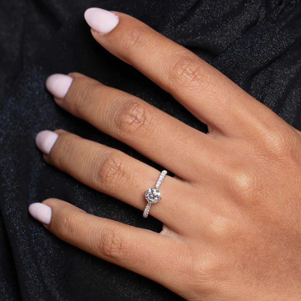 White gold round engagement ring on ladies hand