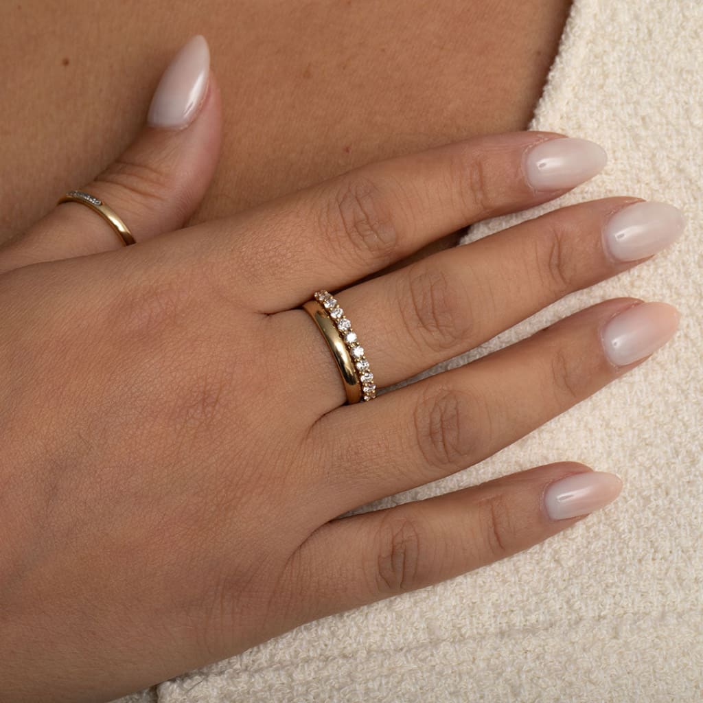 yellow gold diamond wedding ring on models hand 2