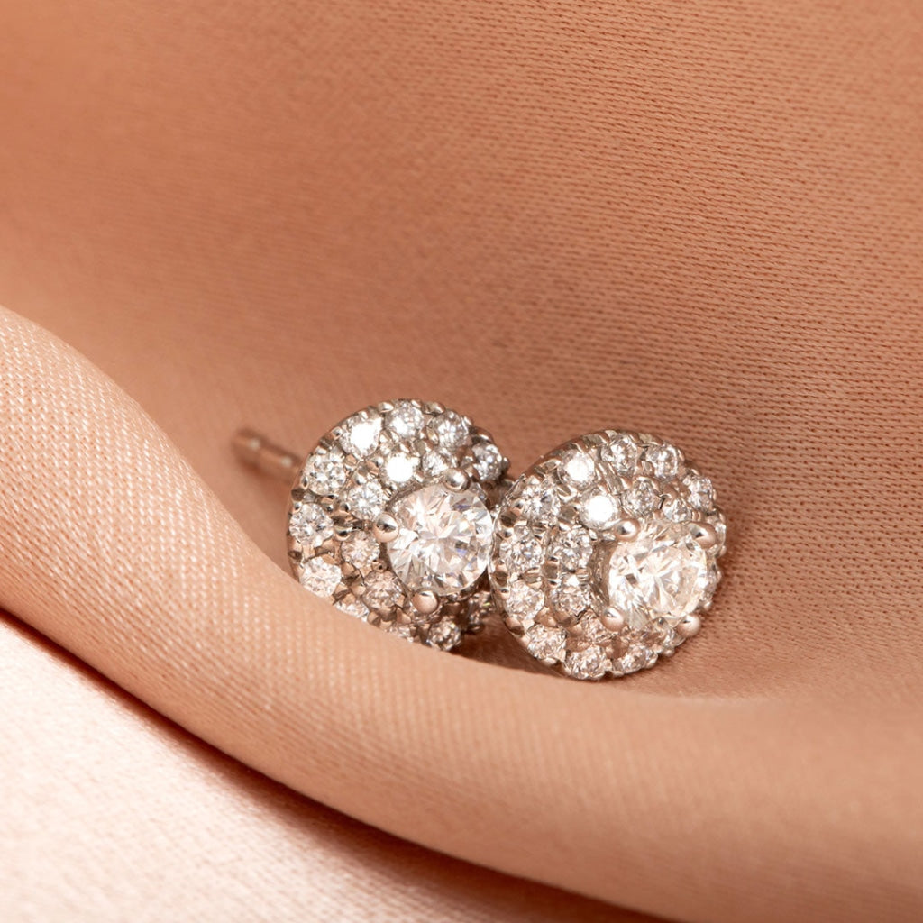 round diamond earrings on fabric