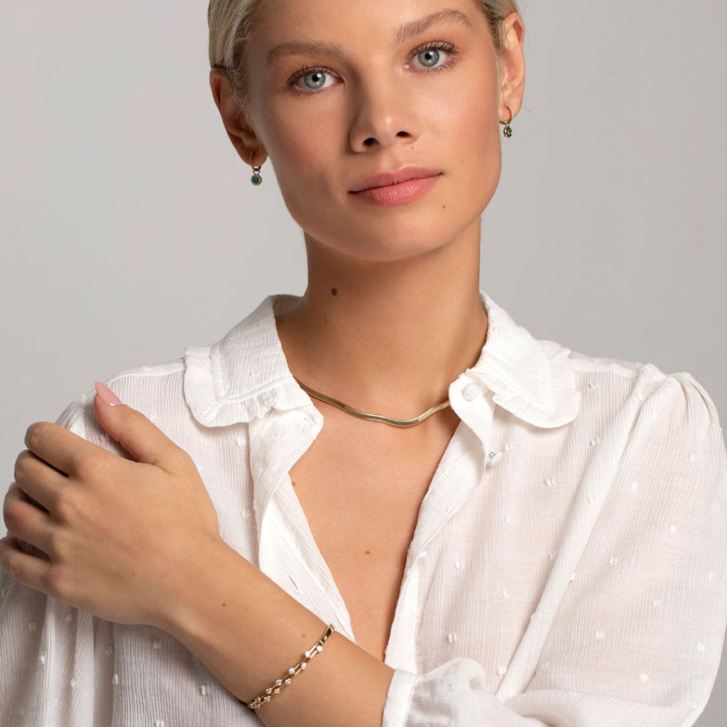 model wearing selection of yellow gold jewellery