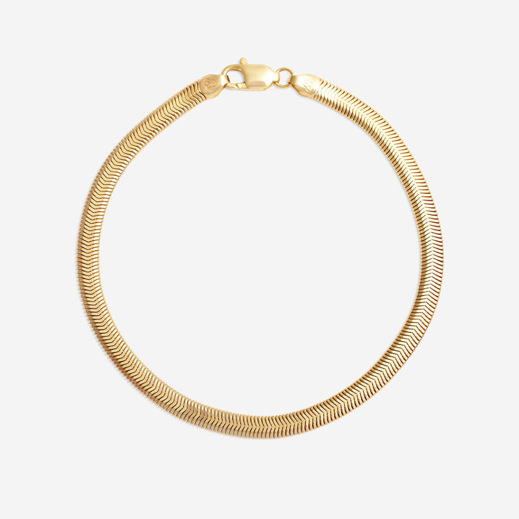 yellow gold snake chain bracelet on white