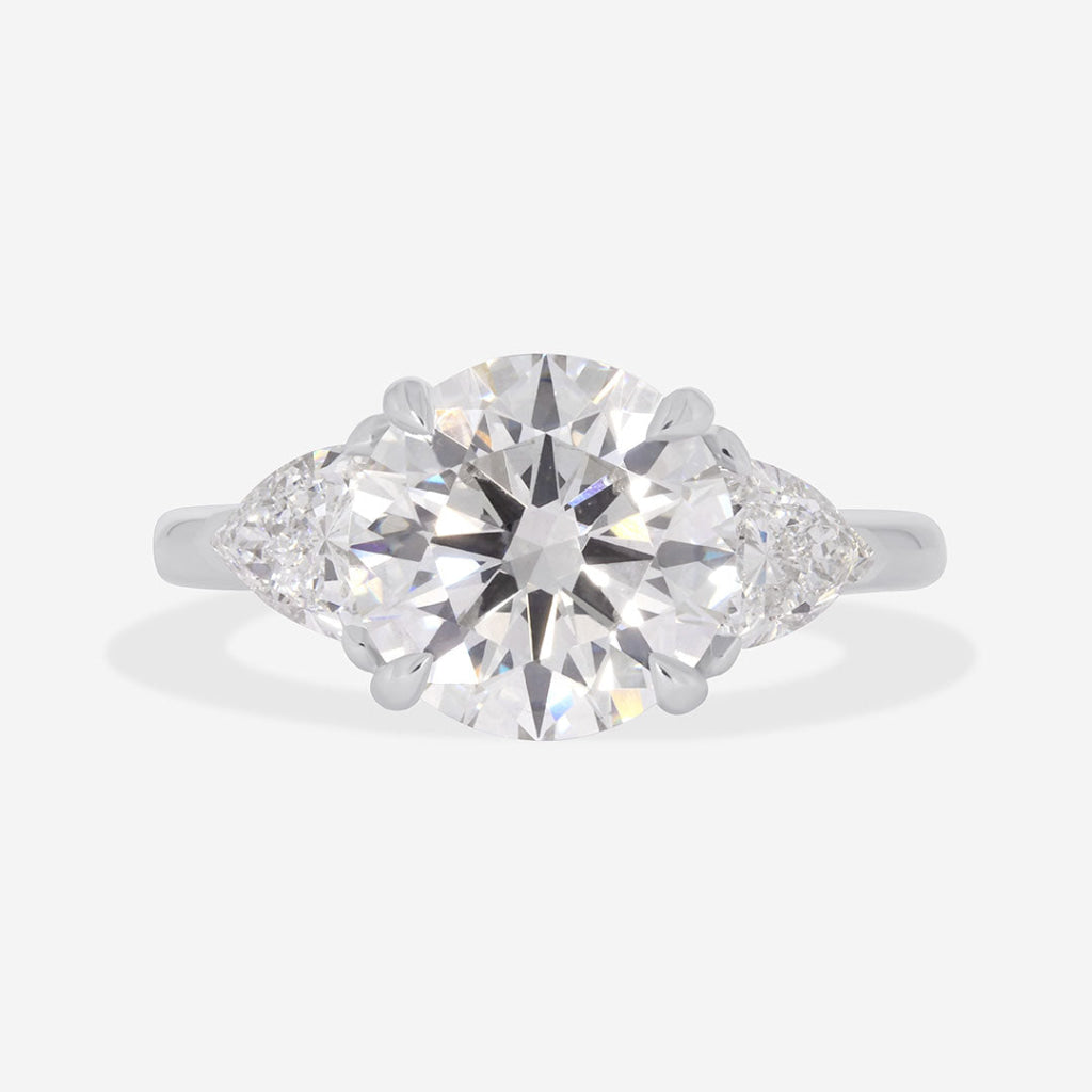 round diamond engagement ring with pear diamonds